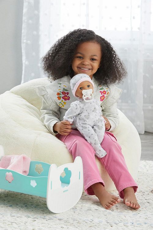 Young Girl playinf with Adopton Day Baby Doll by Madame Alexander