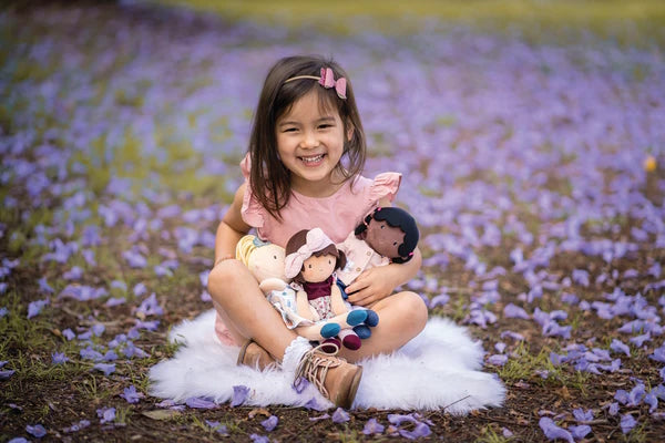 For size comparison, a young model holding three Bonikka dolls including Alicia