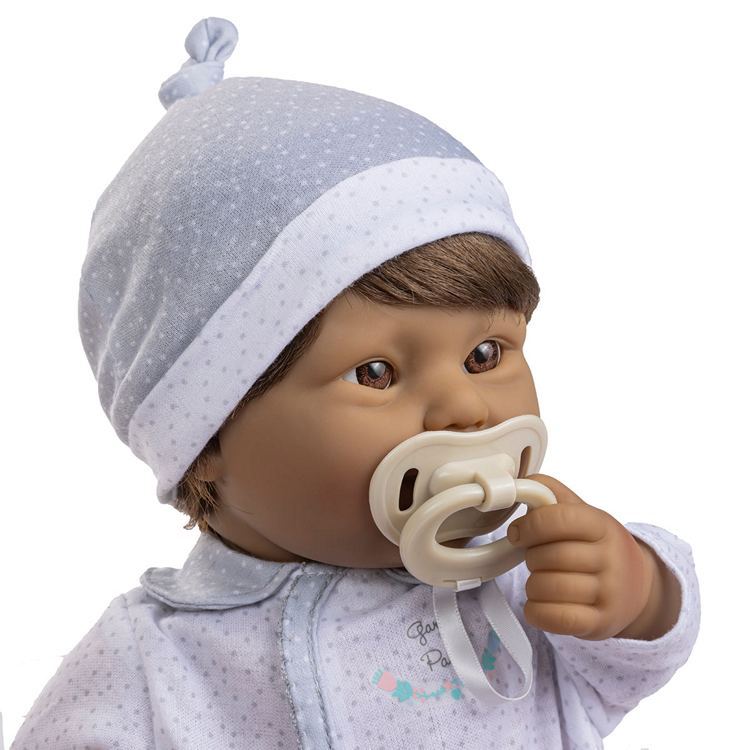 Down Syndrome Baby doll with a pacifier wearing a gray hat and outfit on a white background