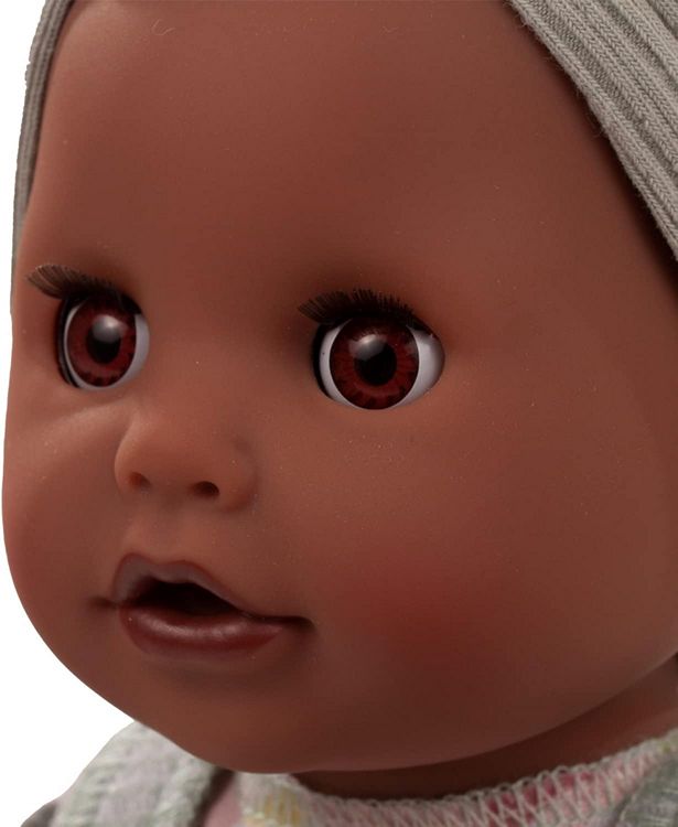 Close-up of a black baby doll with detailed facial features and a neutral background