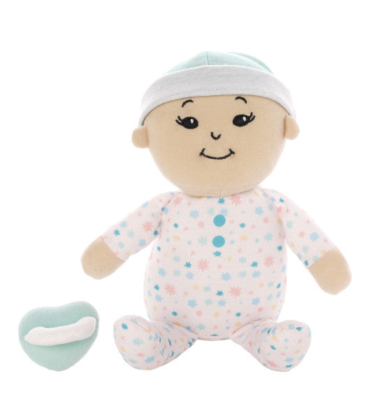 Baby Safe first Asian Doll for children sitting next to pacifier