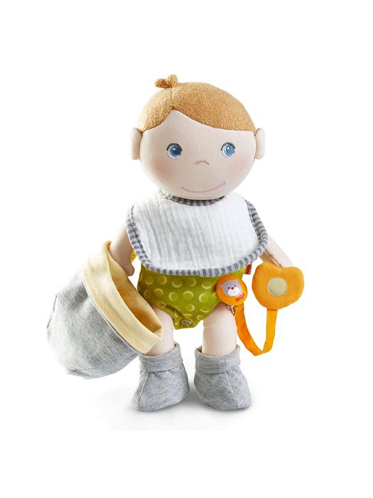 Maxine Doll shown holding the removable cap and the pacifier and wearing the bib