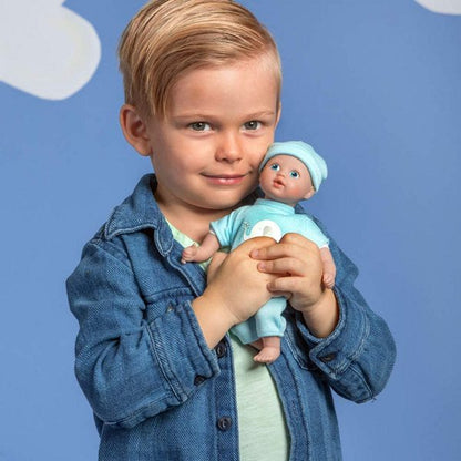 young boy holding his baby boy doll 