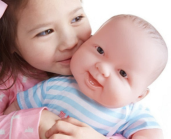a young girl hugging her lifesized cuddle me baby doll by JC Toys