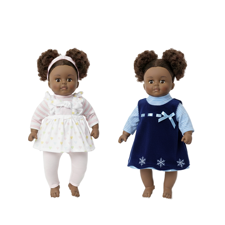 Two Black dolls with natural hair wearing dresses against a white background