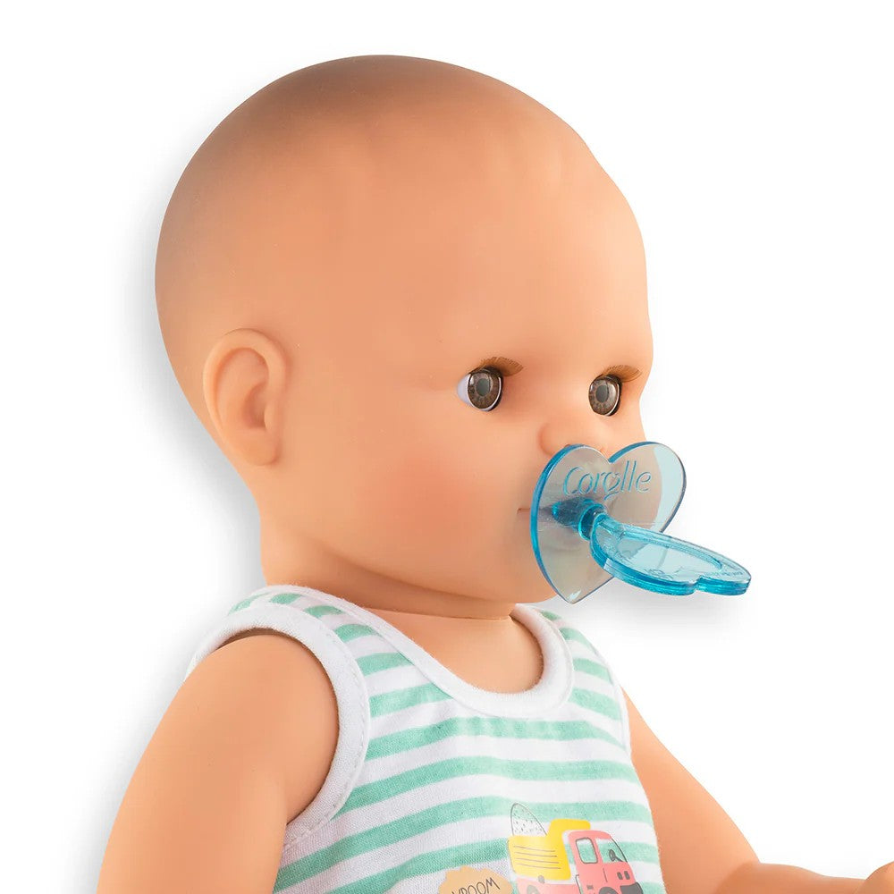 Close up portrait of Corolle Baby Paul 14 inch drink and wet boy doll with brown eyes and blue heart pacifier