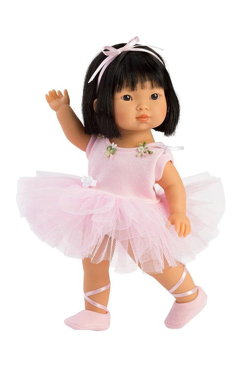 Asian children's doll in a pink ballet outfit with a tutu on a white background