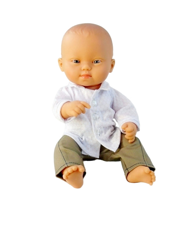 Down Syndrome Baby boy doll wearing a white shirt and green pants on a white background