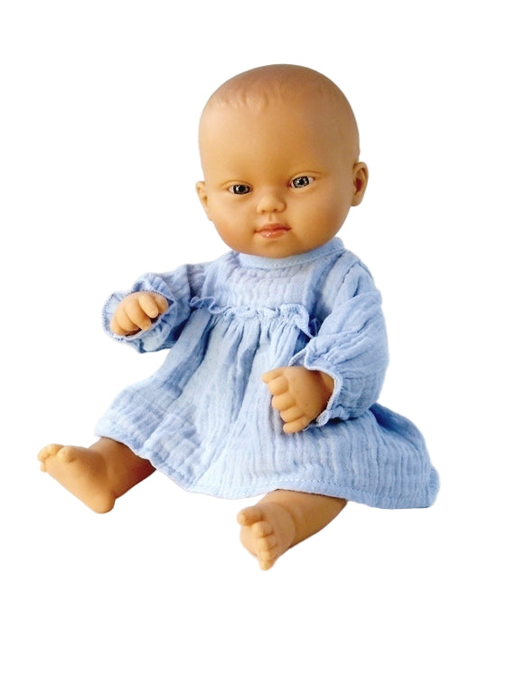 Girl Down Syndrome Baby doll wearing a blue dress on a white background