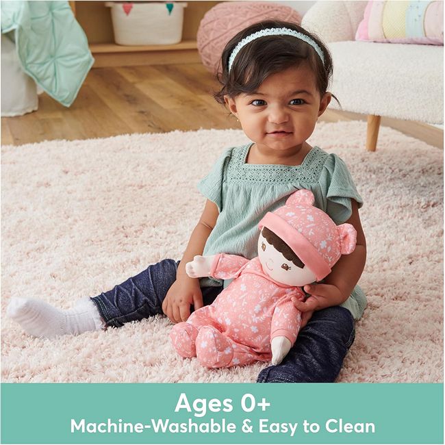 A young girl playing with GUND's eco-friendly Asian Baby's First Doll and Lovey