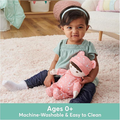 A young girl playing with GUND's eco-friendly Asian Baby's First Doll and Lovey