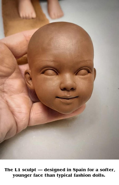 Handcrafted clay sculpt of the L1 doll face held in hand showing the soft rounder younger facial features designed in Spain for the Lorelei and Friends collection