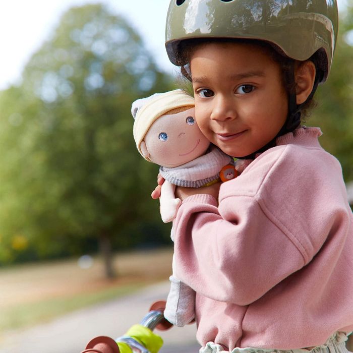 Model hugging a HABA Maxime doll