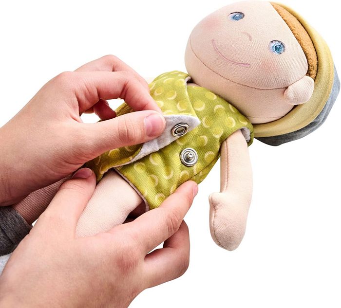 picture of the Maxine Dolls with a child's hands snapping the coverall closed