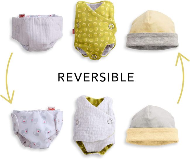 Maxine cloth doll has removable outfits. Showing the reversable cap the reversable onesie and the reversable diaper 