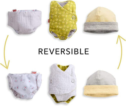 Maxine cloth doll has removable outfits. Showing the reversable cap the reversable onesie and the reversable diaper 
