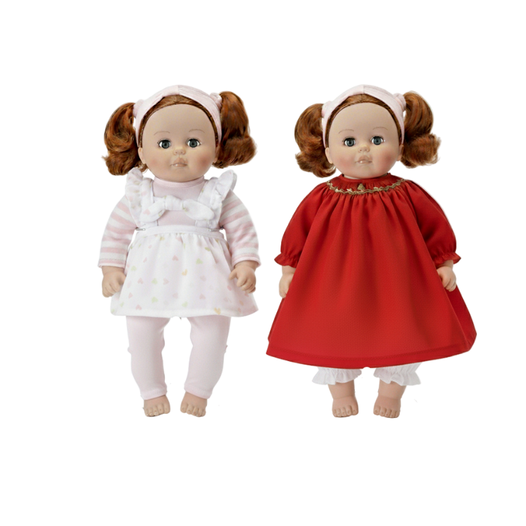 Two redhead dolls one in a red xmas dress and one in a white dress on a white background