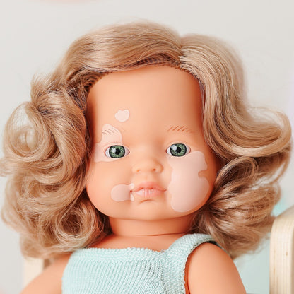 A Portrait of Amy, a doll with vitiligo, Miniland Educational's vitiligo doll