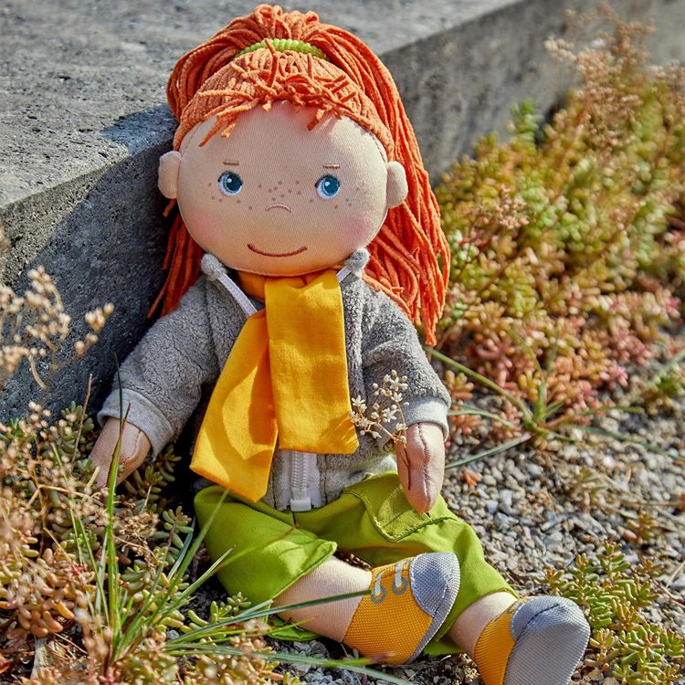 Soley a red head rag doll by HABA  lifestyle picture sitting on the sun