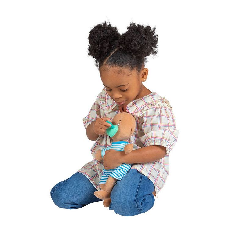 A young Black girl playing with a wee baby fella brown baby doll