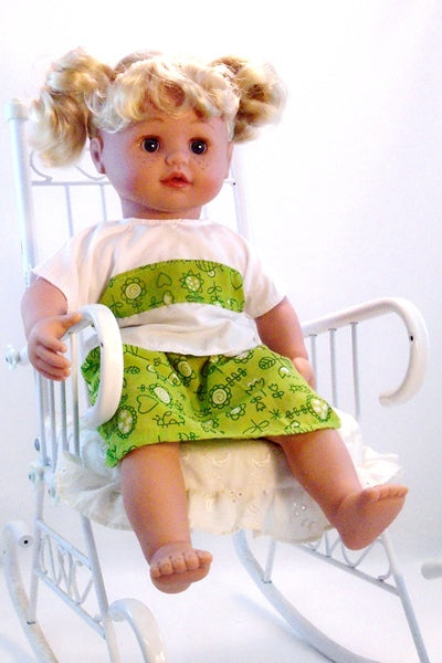 An Adora 15 inch talking doll in a Miniland Educational 15 inch doll's dress