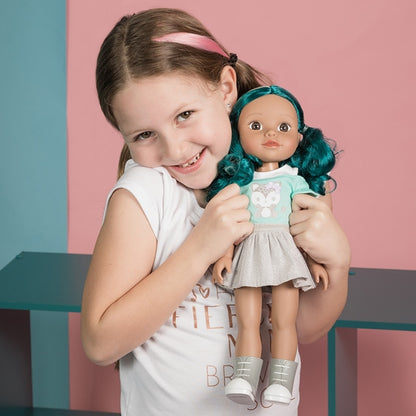 A young model showing the Hispanic / multicultural / biracial doll Alma from Adora