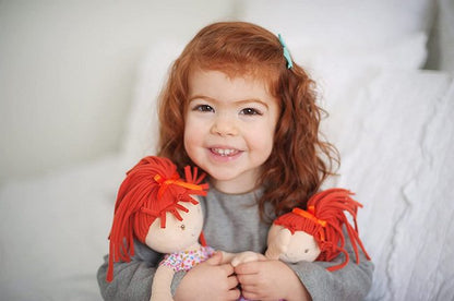 an adorable redhead model holds her redhead ragdoll emmy lu by Bonikka Dolls
