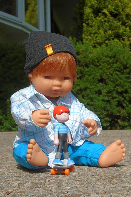 Here's our little redheaded boy doll from Miniland Educational in his criscross 4 pc clothing set