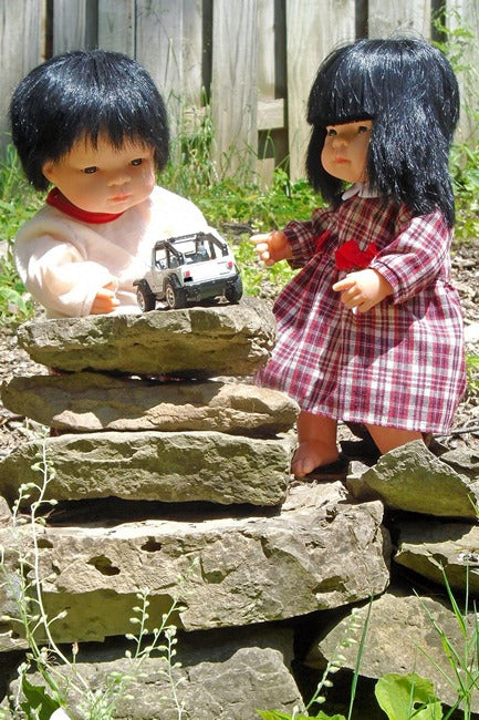 an Asian Boy Doll and an Asian Girl Doll modeling 15 inch doll clothes from Miniland Educational