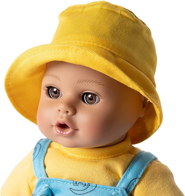 A close up view of Dino Boy multiracial baby doll for boys