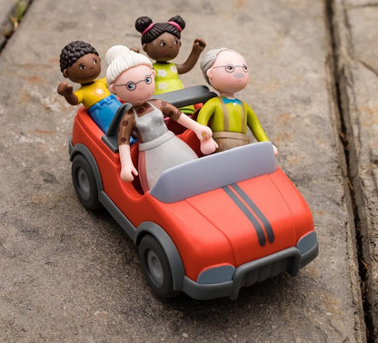  Black Doll house girl and boy riding in a toy car with HABA's two Granparent dollhouse dolls