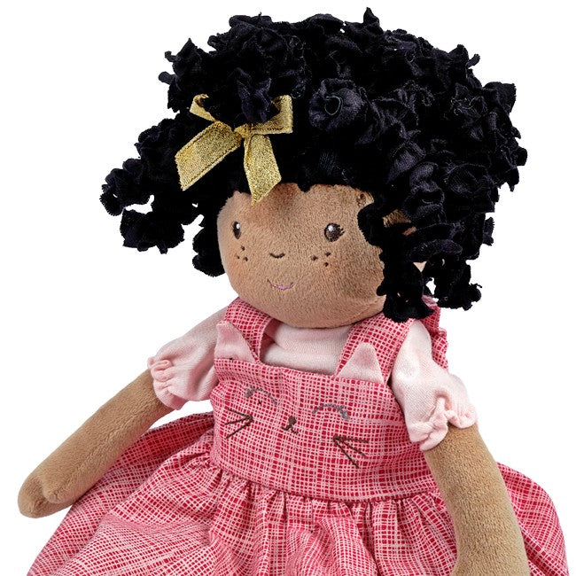 A close up view of a black girl rag doll with twist for hair