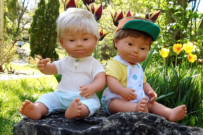 Two boy dolls with down syndrome one with blond hair and one with brown hair
