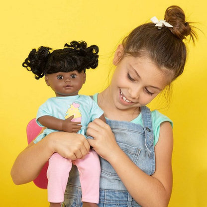 For size comparison, model holding Black Crybaby Interactive doll by Adora
