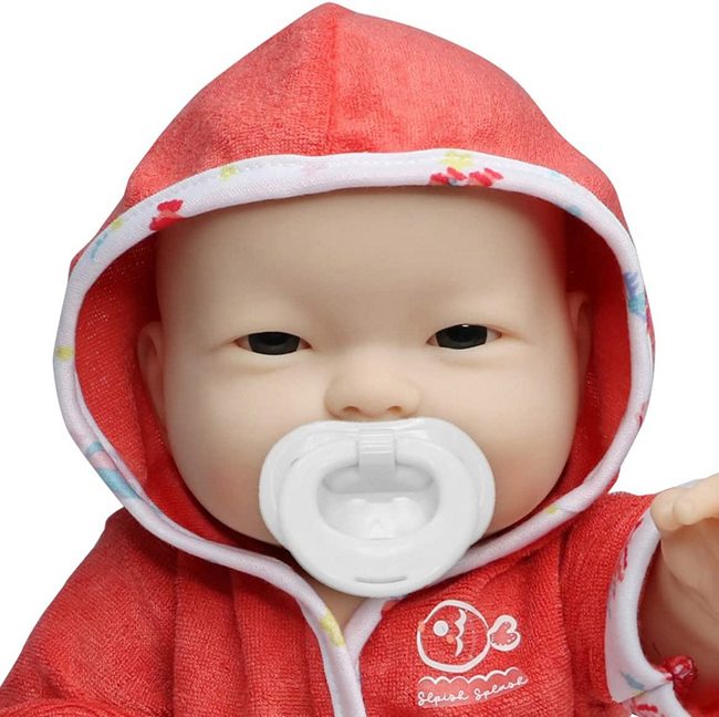 close up portrait picture of Asian Babay doll with included pacifier