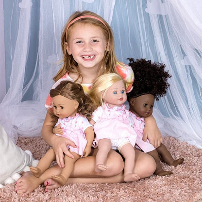 Young model holding three hair styling dolls