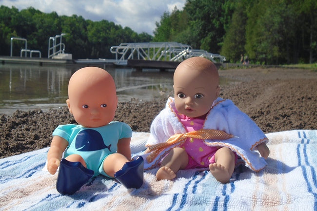 Two children's dolls that can go in the water at the beach